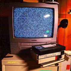 an old tv sitting on top of a stack of books