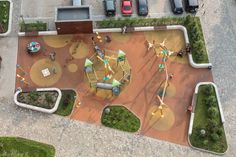 an aerial view of a playground with cars parked in the parking lot and children's play area