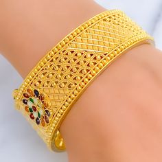 This 22k gold screw bangle weighs 47.7 grams and is adorned with vibrant Meenakari flower designs, giving it a colorful and artistic flair. The bangle has a size of 2.5 inches and an opening diameter of 2.3 inches, featuring a secure screw with hinge mechanism for easy opening and closing. This exquisite piece combines traditional Meenakari artistry with the timeless appeal of gold, making it a perfect accessory for adding a splash of color and elegance to any outfit. PRODUCT DETAILS Gold Purity(karat): 22k Gold Weight(grams): 47.7 Item Finish: Yellow Gold Bangle Size: 2.5 Bangle Opening(diameter): 2.3" Openable: Yes, Screw w/ Hinge Number Of Pieces: 1 Bangle 22k Gold Meenakari Bangle Bracelet, Yellow Gold Meenakari Bangle As Gift, Yellow Gold Meenakari Bangle For Gifts, Yellow Gold Meenakari Bracelets As Gift, 22k Gold Meenakari Bracelets As Gift, Yellow Gold Meenakari Bangle, Yellow Bangle With Intricate Design For Festivals, Multicolor Bangle With Intricate Design For Gift, Multicolor Bangle With Intricate Design As Gift