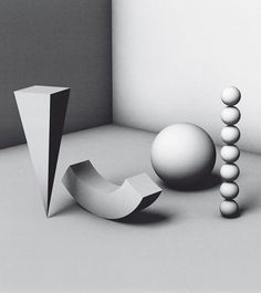 an abstract black and white photo with three balls in the foreground, one on the ground