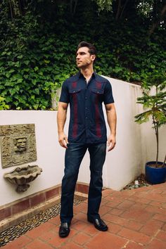 Measurements: Model is wearing size Medium. Fit: Relaxed Fit About: This stylish men's Guayabera shirt is perfect for staying cool in the heat. Made with breathable and lightweight material, the Guayabera shirt features traditional Aztec embroidery and four pocketed-details. With a relaxed camp collar and pintuck detailing, you'll look great and feel comfortable wherever you go. Details & Features: Breathable Fabric Pintuck Detailing Embroidered Aztec design Front button fastenings Short Sleeve Fitted Long Sleeve Camp Shirt Casual, Fitted Long Sleeve Casual Camp Shirt, Casual Traditional Fit Summer Tops, Casual Traditional Fit Shirt For Summer, Traditional Fit Short Sleeve Tops For Summer, Mens Guayabera Shirts, Aztec Embroidery, Guayabera Shirt, Aztec Design