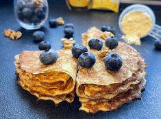 pancakes with blueberries and walnuts on a table