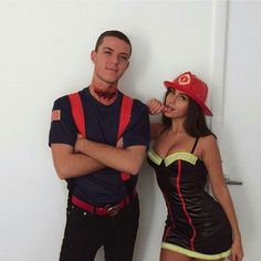 a man standing next to a woman wearing a costume that looks like firefighters