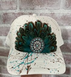 Beautifully colored and designed with hand picked feathers. We added the perfect embellishment to top off this gorgeous handmade trucker hat. Hat features an adjustable snap back for the perfect fit. Hats will vary as they are hand designs and no two are alike Artisan Hats With Feathers And Adjustable Fit, Adjustable Country Hat With Feather Trim, Embellished Trucker Hat, Handmade Bohemian Trucker Hat, Trucker Hat Outfit Women, Hats With Feathers, Feather Trucker Hat, Adjustable Feather Trim Hat For Western-themed Events, Boho Western Outfits