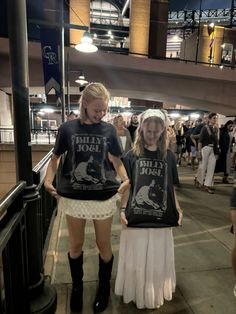 two girls wearing t - shirts that read killer bob and are standing next to each other