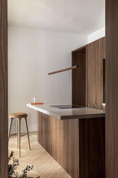 a kitchen with an island and stools next to it in the middle of a room