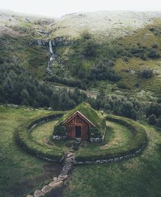 an image of a house in the middle of a field with grass growing on it