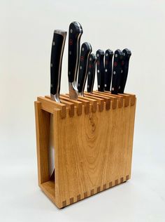 a wooden block with knives in it