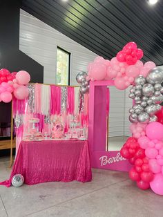 a pink and silver party with balloons