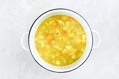 a white bowl filled with soup on top of a table