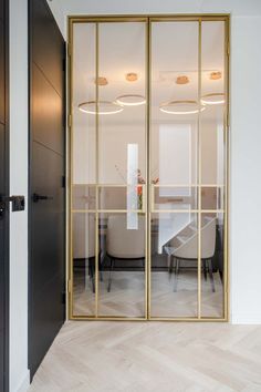 an open glass door leading to a dining room