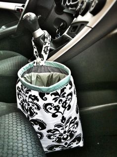 the interior of a car with a black and white bag hanging from it's center console