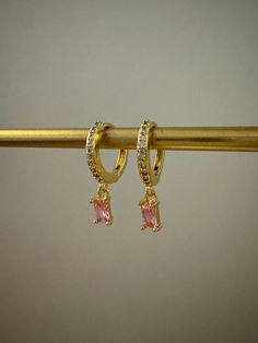 The cubic zirconia version of our barbie pink baguette hoops 💖 they're so sparkly & such a pretty pair of hoops. Perfect for everyday wear and they stack with other earrings so well💕 Materials ✨ The hoops are created with brass, making them more lightweight compared to my stainless steel hoops. The charm is cubic zirconia & both are 18k gold plated so they will keep their gorgeous gold shine ✨ your order will come in a reusable pouch for storage and makes a perfect way to gift.  Sizing:  Hoops: 15x14x2mm Charm: 8x4x3mm Jewellery care ✨ To maintain the shine of your hoops, please remove before sleeping, showering or going to the gym and apply any perfume or oils before putting them on🫶 Free UK shipping ✨ (tracked 48) 1-3 day dispatch. Upgrade to tracked 24 available at checkout 🫶 Intern Trendy Pink Cubic Zirconia Jewelry, Everyday Pink Huggie Earrings, Trendy Cubic Zirconia Huggie Earrings As Gift, Pink Single Huggie Earring For Everyday, Pink Cubic Zirconia Hoop Earrings, Pink Cubic Zirconia Hoop Jewelry, Pink Dainty Huggie Jewelry, Trendy Cubic Zirconia Hoop Earrings For Gift, Pink Huggie Earrings For Everyday