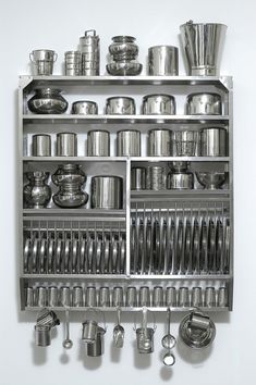 a metal shelf filled with lots of pots and pans