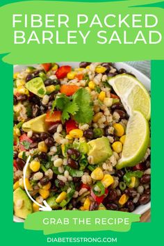 a bowl filled with black beans, corn and avocado next to a lime wedge