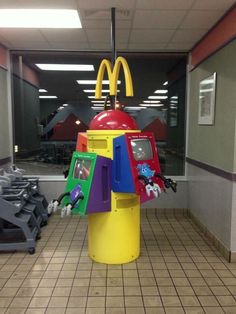 a mcdonald's arcade machine in the middle of a tiled floored room with windows