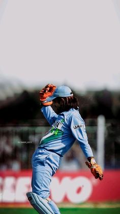 a baseball player throwing a ball on top of a field with his glove in the air