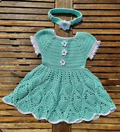 "Welcome To SaminasCrochetDesign In search for the perfect unique baby gift? Everyone will ask where you got it from. Look no further!  This is a gorgeous handmade crochet dress with a matching headband, it makes a beautiful gift set for a new born up to 6 month old.  I made it in mint green acrylic yarn and its adorned with 3 delicate flower embellishments with white contrast crochet flowers with a green \"jewel\" at its center, which makes the outfit pop! The Princess dress has a full skirt in a \"pineapple\" design with a white contrast trim on the sleeves and full skirt.  The yarn is 4 ply which means the dress is light and delicate and creates a lovely drape. The dress has a square neckline with a cinched waistband to give a better fit.  The sleeves have a lovely puff detail in white Cute Fitted Crochet Cotton Dress, Fitted Crochet Cotton Dress In Cute Style, Cute Fitted Crochet Dress, Hand Knitted Cute Cotton Dresses, Cute Hand Knitted Cotton Dresses, Hand Knitted Cotton Dresses In Cute Style, Hand-knitted Cotton Dresses In Cute Style, Handmade Cotton Crochet Dress, Handmade Crochet Dress For Spring