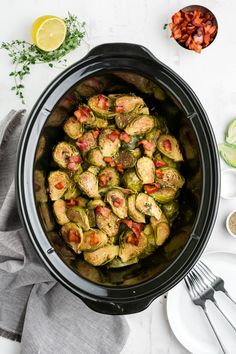 a crock pot filled with cooked brussel sprouts