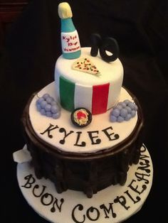 a cake that has been decorated with wine and other things on the top of it