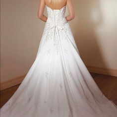 a woman in a white wedding dress looking back