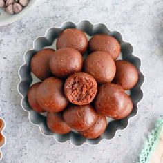 a bowl filled with chocolate truffles on top of a table next to other ingredients