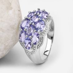 "Tanzanite Ring, Real Tanzanite Cluster Ring in .925 Sterling Silver with Rhodium Plating, for Women, December Birthstone Ready for radiance? Add a flash of radiance with this glittering cluster ring. The ring features a sensational jewel cluster made up of 10 oval-cut purple tanzanite stones. The gemstones have a combined weight of 2.66 carats, and the band is crafted from .925 sterling silver with a rhodium plating finish. Product Details: Metal: .925 Sterling Silver Gross Wt: 4.11 Grams Gemst Silver Tanzanite Jewelry With Center Stone, Sterling Silver Gemstone Cluster Ring, Silver Tanzanite Jewelry With Accent Stones, Silver Sterling Cluster Ring With Accent Stones, Silver Tanzanite Multi-stone Rings, Silver Tanzanite Promise Ring, Silver Tanzanite Hallmarked Rings, Silver Tanzanite Rings With Prong Setting, Silver Tanzanite Birthstone Ring As A Gift