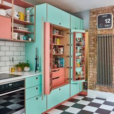 an old fashioned kitchen with pink and blue cabinets