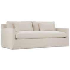 a white couch with four pillows on it