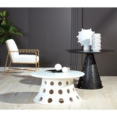 two white chairs and a table in a room with wood flooring on the ground