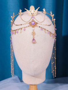 the headpiece is adorned with jewels and pearls