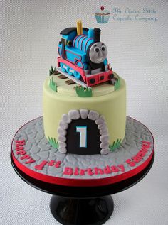 a thomas the train birthday cake on a stand