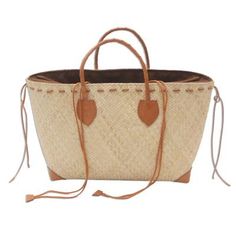 The creamy tones of natural rattan bring beauty to the season. Woven by hand this handbag by Putu Suryawan features handles of braided brown leather. Leather reinforces the corners and forms a handsome lacing around the top. Fully lined the purse has an inner zipper pocket and closes with a drawstring. Rattan Handbags, Louis Vuitton Bag Neverfull, Fashion Street, Leather Handle, Street Style Women, Burlap Bag, Brown Leather, Premium Quality, Reusable Tote Bags