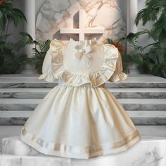 Elegant Baby's Christening Gown - Timeless Baptism Dress for Infants - Classic Girl's Baptism Attire - Heritage Christening Ensemble - Sacred Ceremony Baptism Gown Embrace Tradition: Vintage Christening Gown Welcome a new generation into your family's traditions with our Vintage Christening Gown. This gown is a tribute to time-honored customs, blending classic design with modern comfort. Every stitch tells a story of heritage, making it the perfect choice for your baby's significant day. Symbol of Purity: Christening Dress for Her Our Christening Dress is more than just fabric and lace--it's a symbol of a new beginning. Carefully crafted to honor this special rite of passage, this dress features delicate accents and soft textures, ensuring your little one is the picture of innocence and pu Fitted Off White Baptism Dress With Ruffles, Cream Ruffled First Communion Dress For Baptism, Cream Ruffled Baptism Dress, Elegant Baptism Dress With Ruffles For Church, Cream Baptism Dress With Ruffles For Ceremony, Cream Baptism Dress With Ruffles, Elegant Ruffled Baptism Dress For Church, Cream Short Sleeve Dress For First Communion, White Baptism Dress With Ruffles For Church