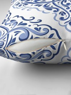 a blue and white pillow with a zipper on the side that has an ornate design