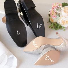 two pairs of shoes with the bride's names on them and flowers in the background