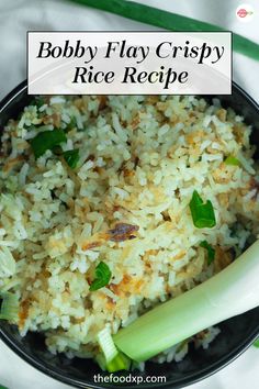 a black bowl filled with rice and celery