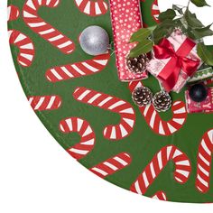 a green table topped with candy canes and presents