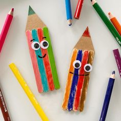 colorful pencils and crayons with faces drawn on them