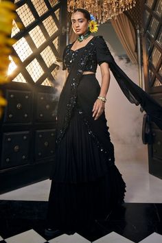 Black pre-draped tiered saree with sequin bloom embroidery on the borders. Paired with a puffed sleeves sweetheart neck sequin embellished bodice blouse. - Aza Fashions Elegant Choli With Draped Sleeves In Georgette, Elegant Georgette Choli With Draped Sleeves, Elegant Festive Choli With Draped Sleeves, Elegant Designer Choli With Draped Sleeves, Glamorous Draped Georgette Choli, Festive Pre-draped Party Sets, Evening Party Wear Sharara With Traditional Drape, Party Wear Sharara With Traditional Drape For Evening, Party Wear Sharara For Evening With Cape Sleeves