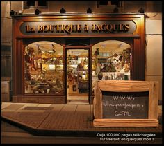 a store front with an assortment of items on display in it's windows at night