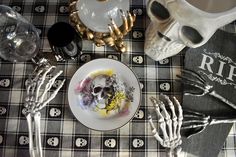 the table is decorated with skulls and skeleton dishes