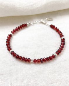 Faceted garnet beads sparkle within this bracelet, complemented by sterling silver components. Let January's birthstone brighten your look. Bracelet length: 7 inches plus 1-inch extender Materials: 4 mm garnet beads, sterling silver Elegant Adjustable Garnet Bracelets, Elegant Sterling Silver Crystal Bracelet With Faceted Beads, Elegant Sterling Silver Beaded Bracelet With Faceted Beads, Elegant Sterling Silver Crystal Bracelet With Gemstone Beads, Elegant Sterling Silver Bracelets With Faceted Beads, Sterling Silver Rondelle Gemstone Beaded Bracelets, Classic Faceted Bracelets As Gifts, Elegant Sterling Silver Beaded Bracelets With Gemstone, Elegant Sterling Silver Gemstone Beads Bracelet Gift