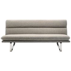 a gray couch sitting on top of a metal frame