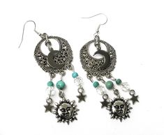 "Fun, flirty earrings with celestial charm that feature sun, half moon, and star charms swinging from filigree pendants with turquoise magnesite and glass bead accents! It's a super-cute pair of earrings to slip on to add that funky finishing touch to your outfits! And the're lightweight, too, so they're really comfortable to wear...no pulling as they swing! Choose your earwires...sterling silver or silver-plated! Sterling Silver/Silver-plated Earwires, Silver-plated Filigree Pendants 1\" round, Celestial Sun And Moon Dangle Jewelry, Celestial Metal Jewelry With Dangling Charms, Celestial Nickel-free Jewelry For Festivals, Festival Sun And Moon Dangle Jewelry, Celestial Style Nickel-free Jewelry For Festivals, Bohemian Dangle Earrings With Sun And Moon Design, Bohemian Jewelry With Dangle Moon Charm, Adjustable Sun And Moon Design Drop Earrings, Bohemian Dangle Charm Earrings