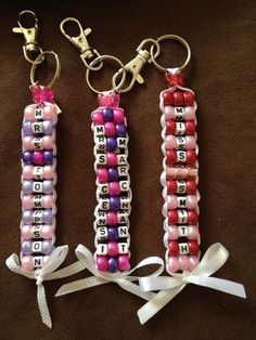 three beaded key chains with words on them