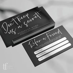 two black and white business cards with silver foil lettering on the front, one has a handwritten message that reads don't keep us at sent