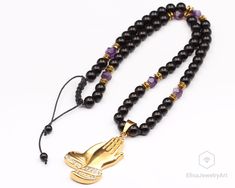 "Prayer Hands Pendant Necklace Amethyst Black Onyx Beaded Adjustable Macrame Protection Crystal Gemstone Long Necklace Christmas Gif For Him -ALL THE PRODUCTS AT ELISAJEWELRYART ARE HANDMADE AND MADE WITH NATURAL BEADS. -WHAT DOES THE AMETHYST STAND FOR The name amethyst translates in Greek to, \"not drunken.\" An ancient Greek myth explains this seemingly odd name. According to the myth, the god Bacchus was angry, and had vowed to descend a hoard of tigers upon the first person who crossed his Onyx Beaded Jewelry For Meditation, Black Amethyst Gemstone Beads Necklace, Black Amethyst Gemstone Beads Jewelry, Purple Necklace With Black Beads For Gift, Gift Purple Necklace With Black Beads, Healing Onyx Jewelry With 108 Beads, Onyx Beaded Necklace With Black Beads As A Gift, Onyx Black Beads Necklace As A Gift, Black Amethyst Beads Jewelry 8mm