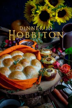 the cover of dinner in hobbiton, featuring rolls and carrots on a table