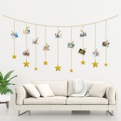 a living room filled with furniture and stars hanging from the wall above it's head